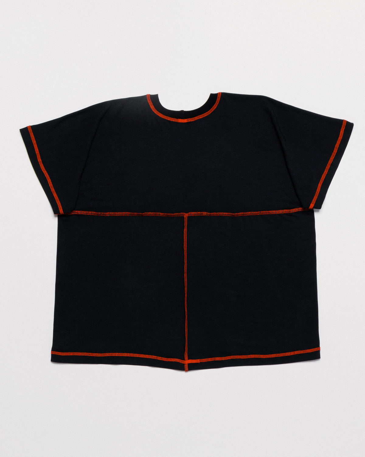 Outnback Bog Tee in black, back flat lay with contrast orange stitching