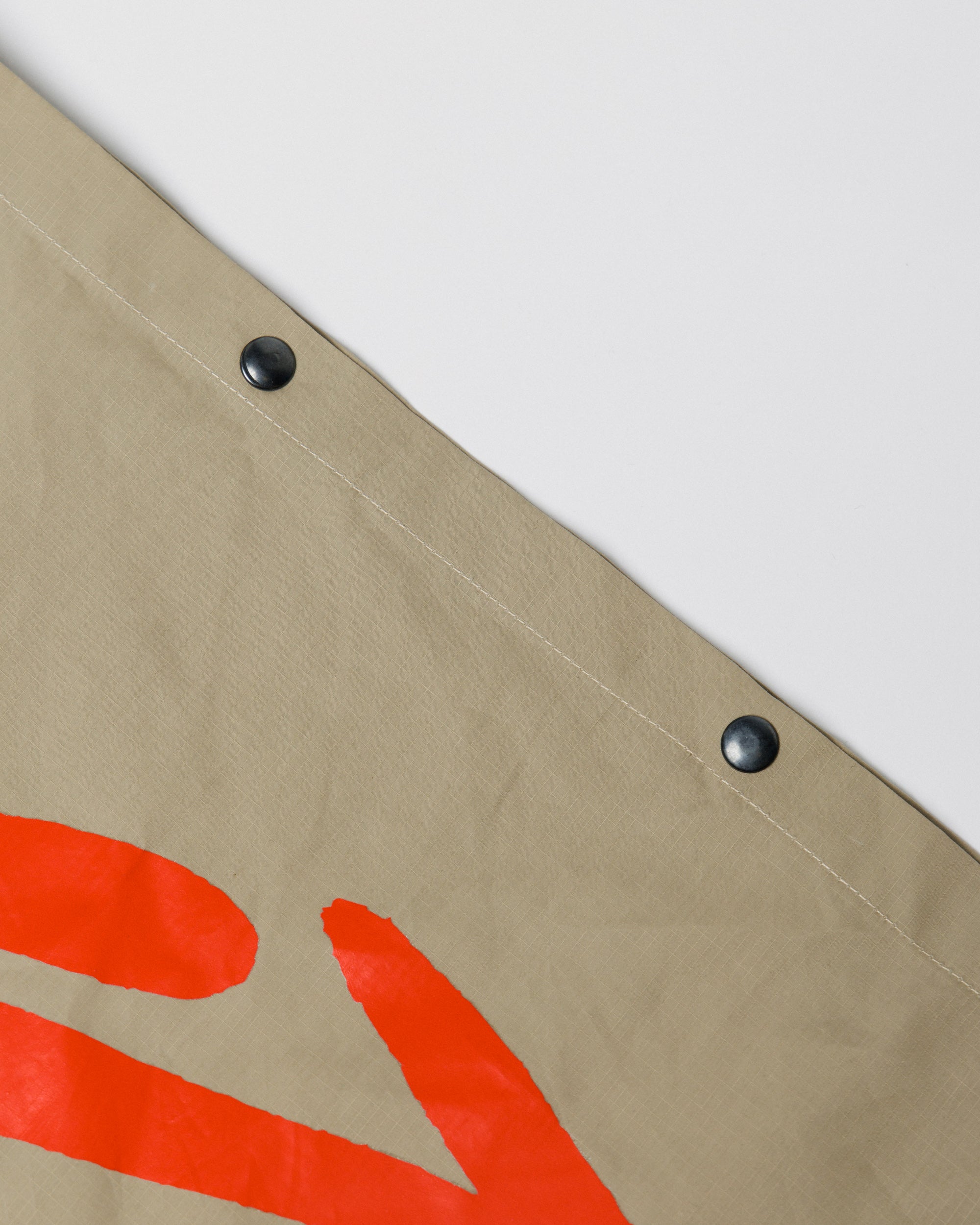 Outnback Musette in stone, popper snap fastening detail