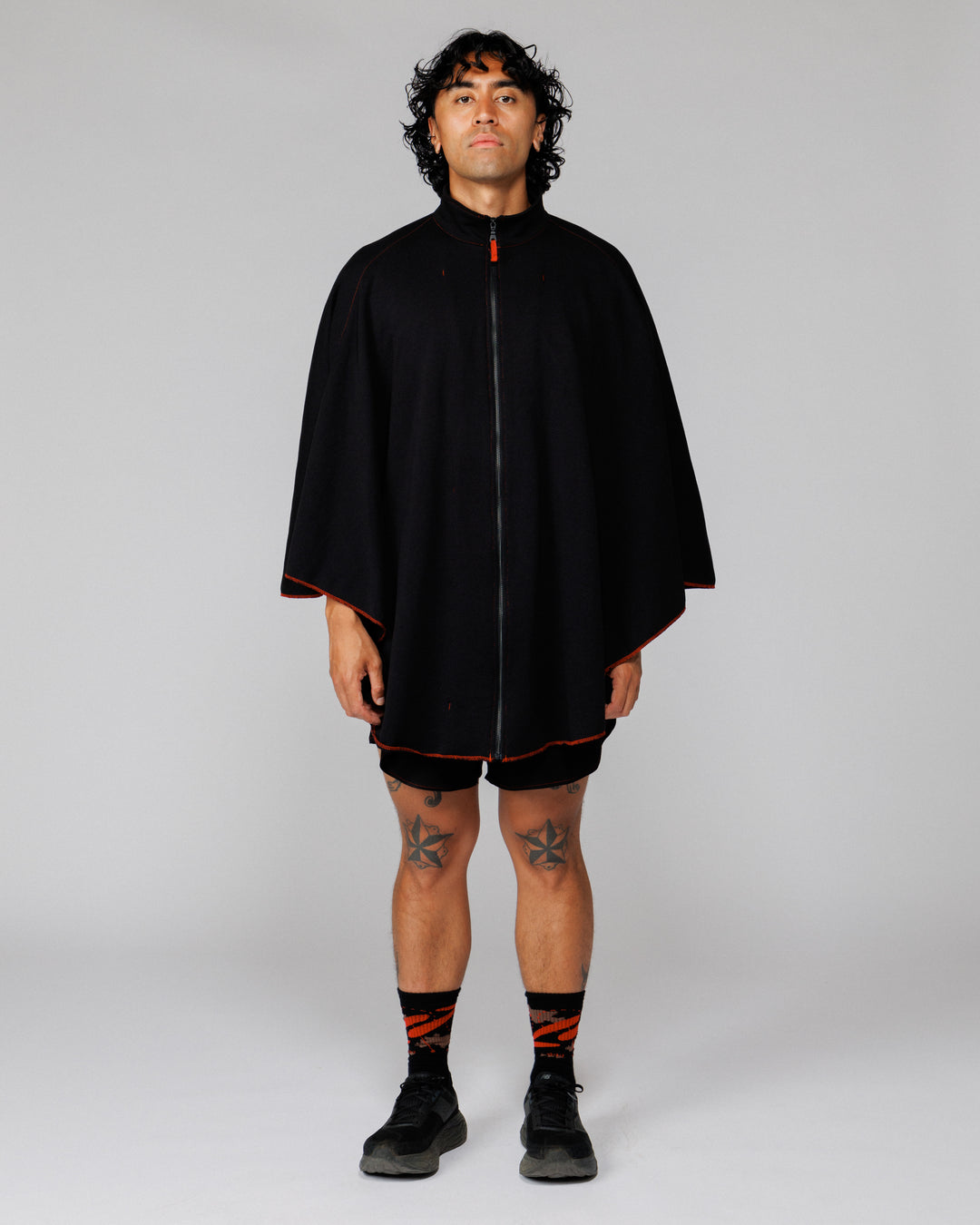 Model wearing the Outnback Recovery Cape in black, full-length front view