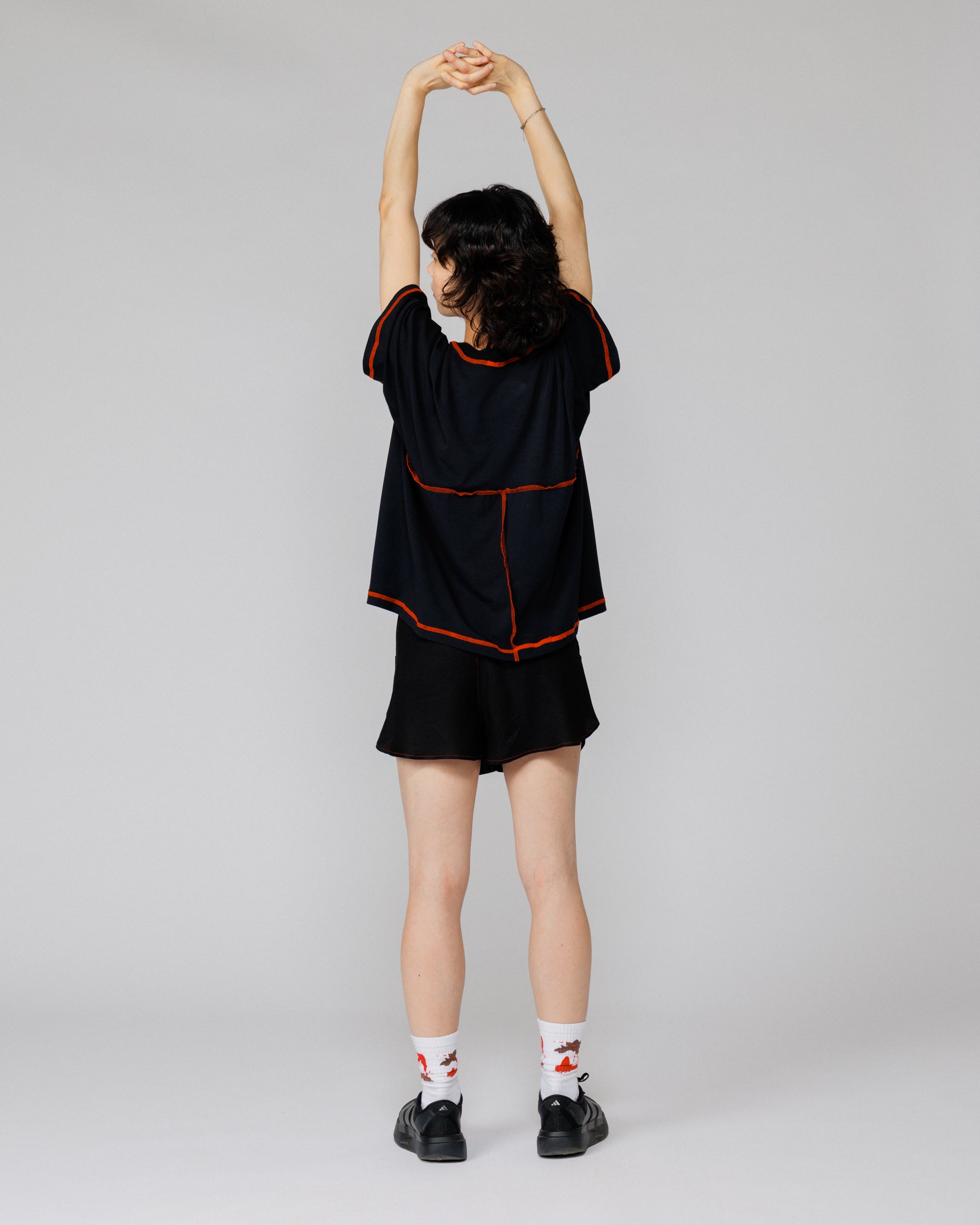 Outnback Running Short in black, back view on model mid-stretch