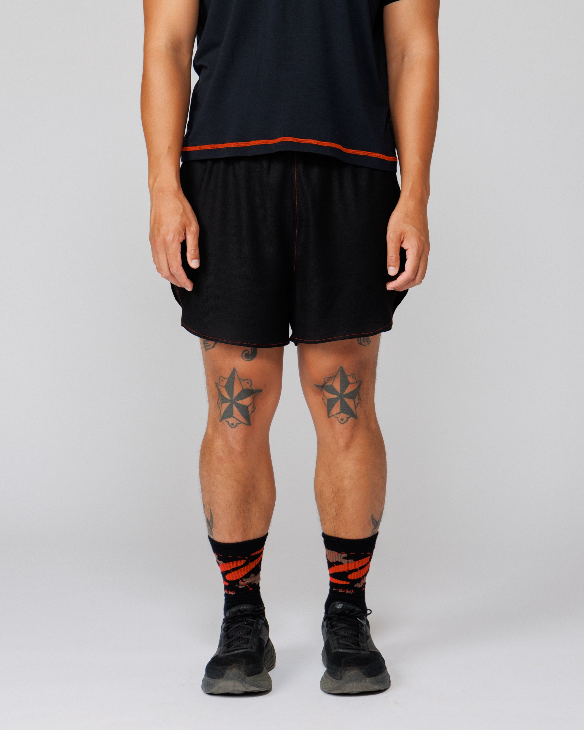 Outnback Running Short in black, cropped front view showing fit through the leg