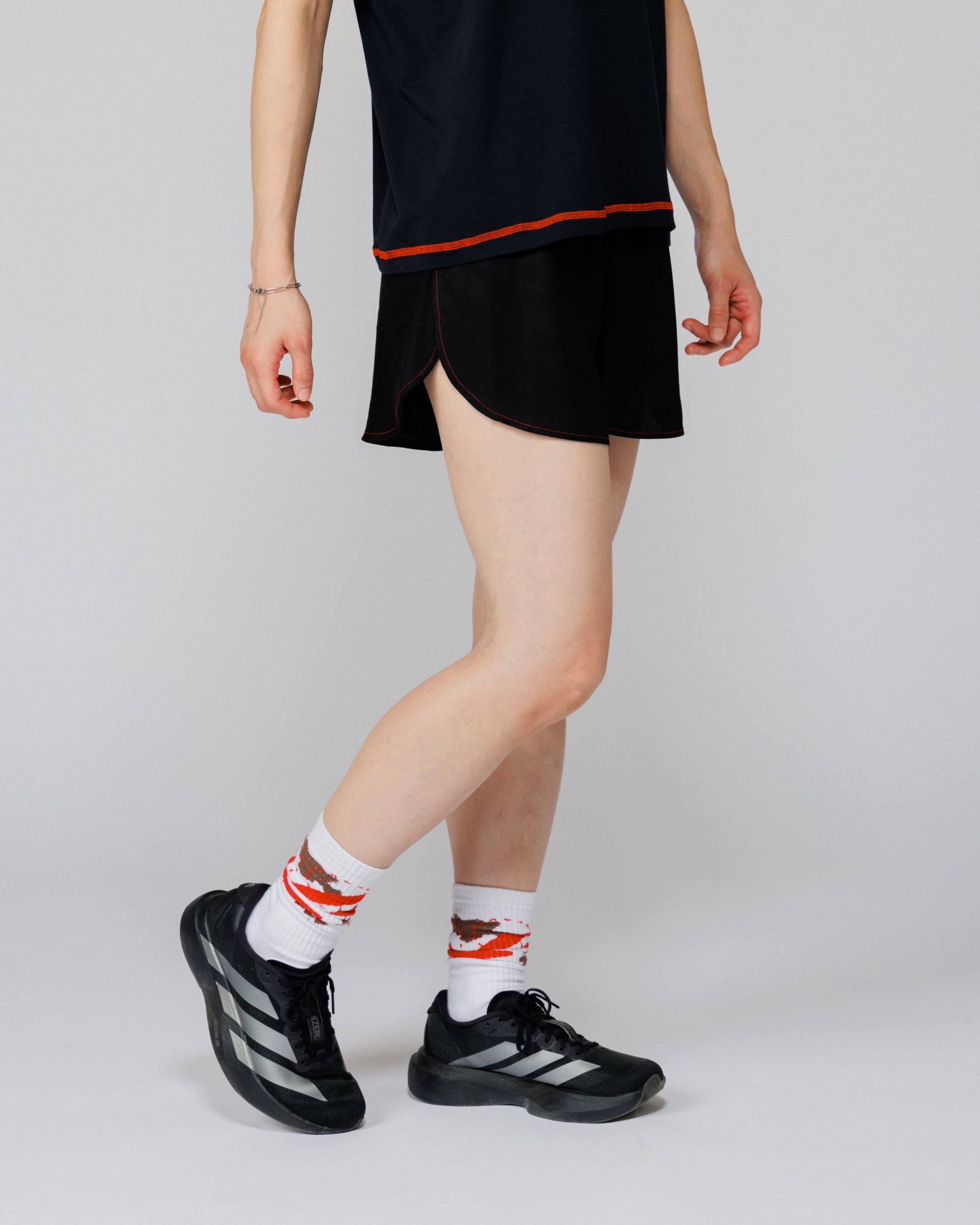 Outnback Running Short in black, cropped view on model mid-stride