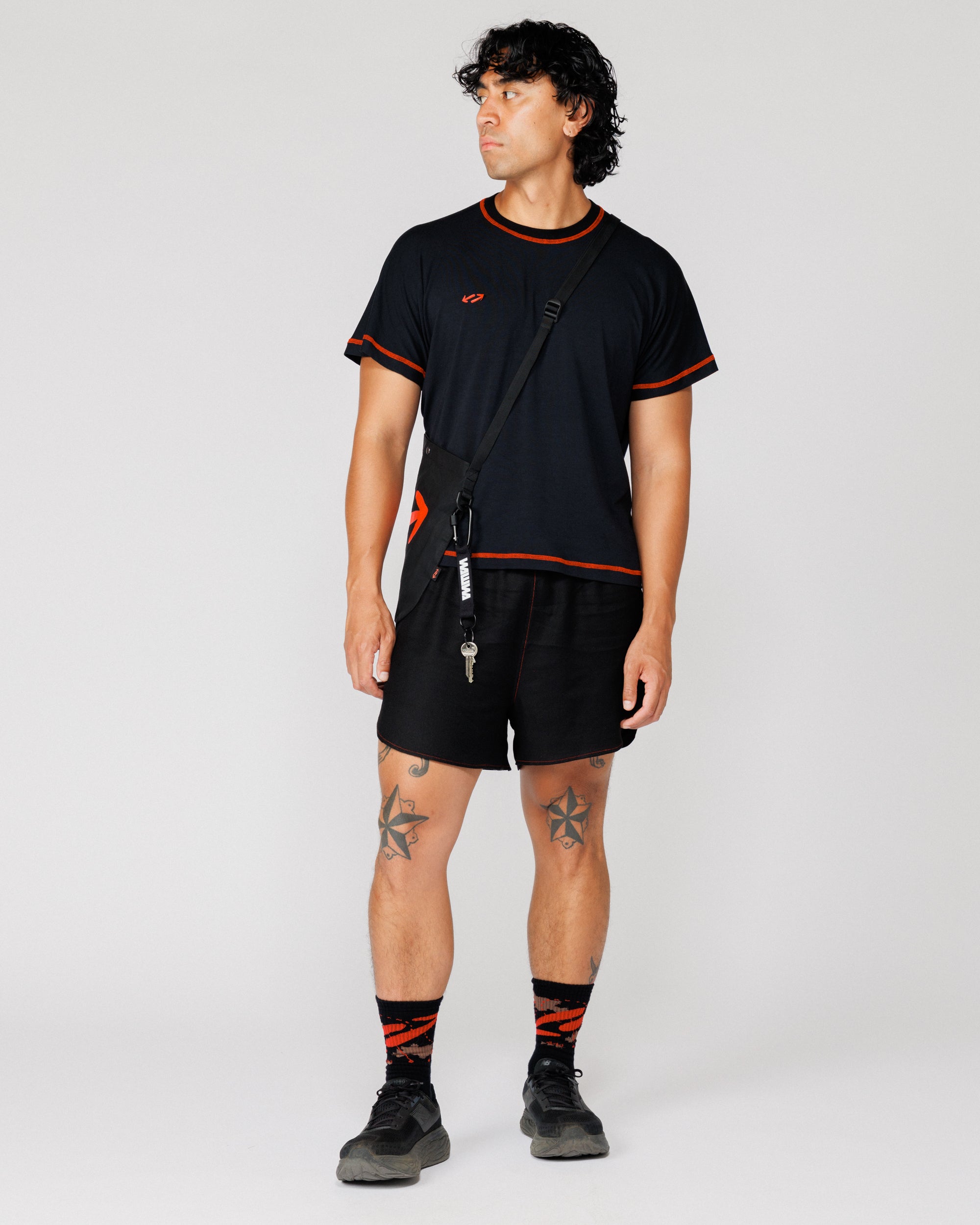 Model wearing the Outnback Running Strap in black crossbody over the shoulder with keys clipped on