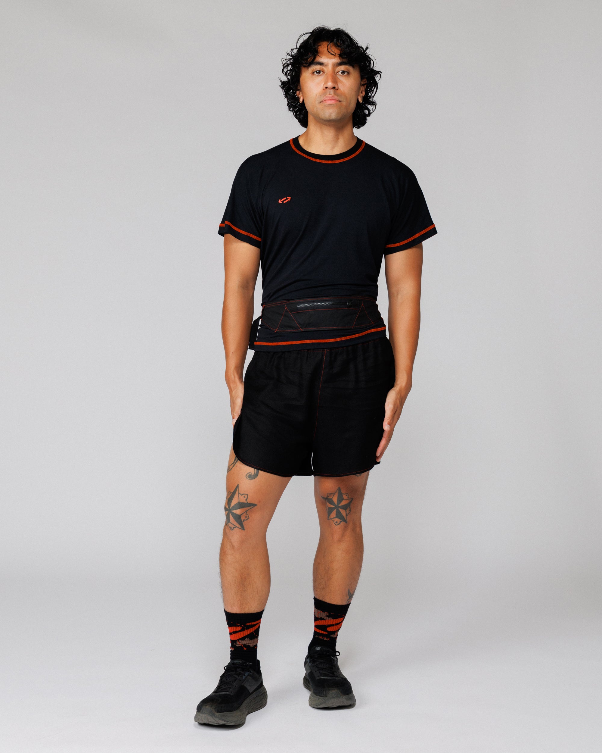 Model wearing the Outnback Running Strap in black at the waist, front view