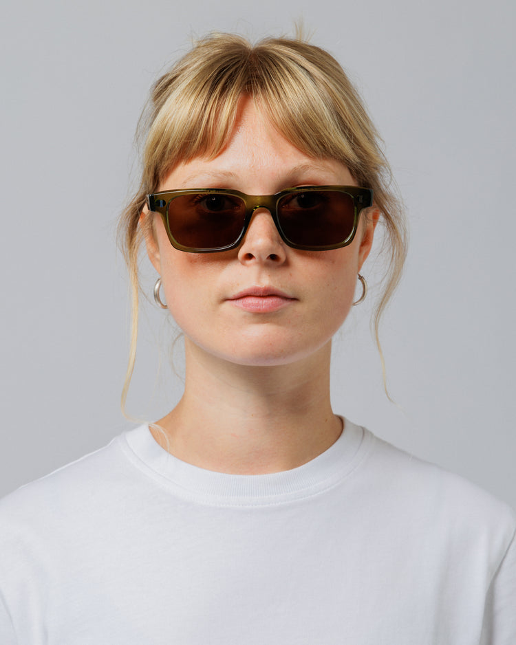 Model wearing Solaris Sunglasses in khaki, front view