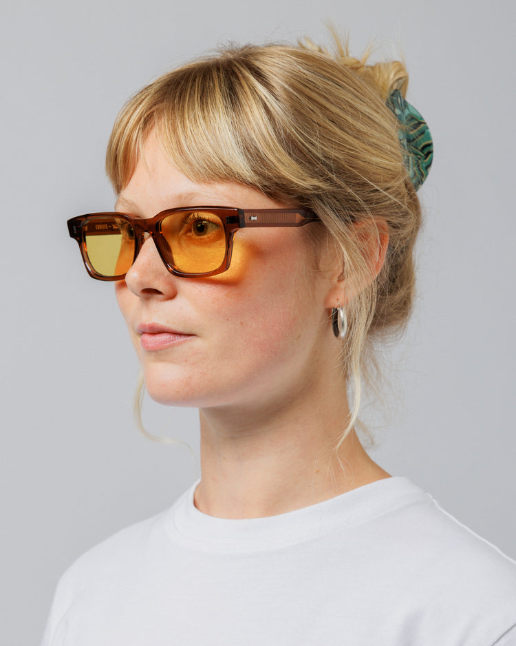Female model wearing Solaris Sunglasses in coconut, three-quarter view