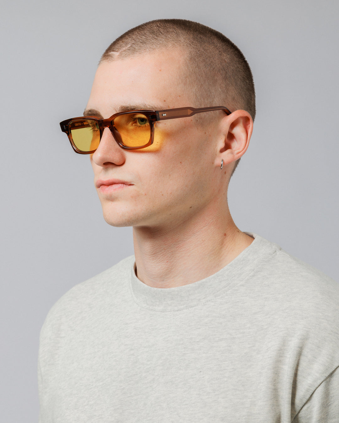 Male model wearing Solaris Sunglasses in coconut, three-quarter view