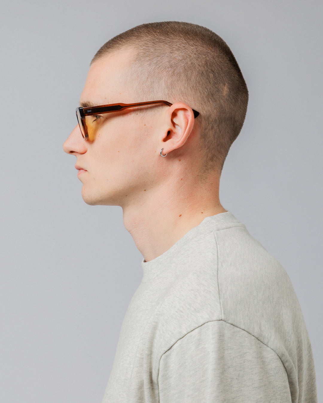 Male model wearing Solaris Sunglasses in coconut, side profile showing temple arm