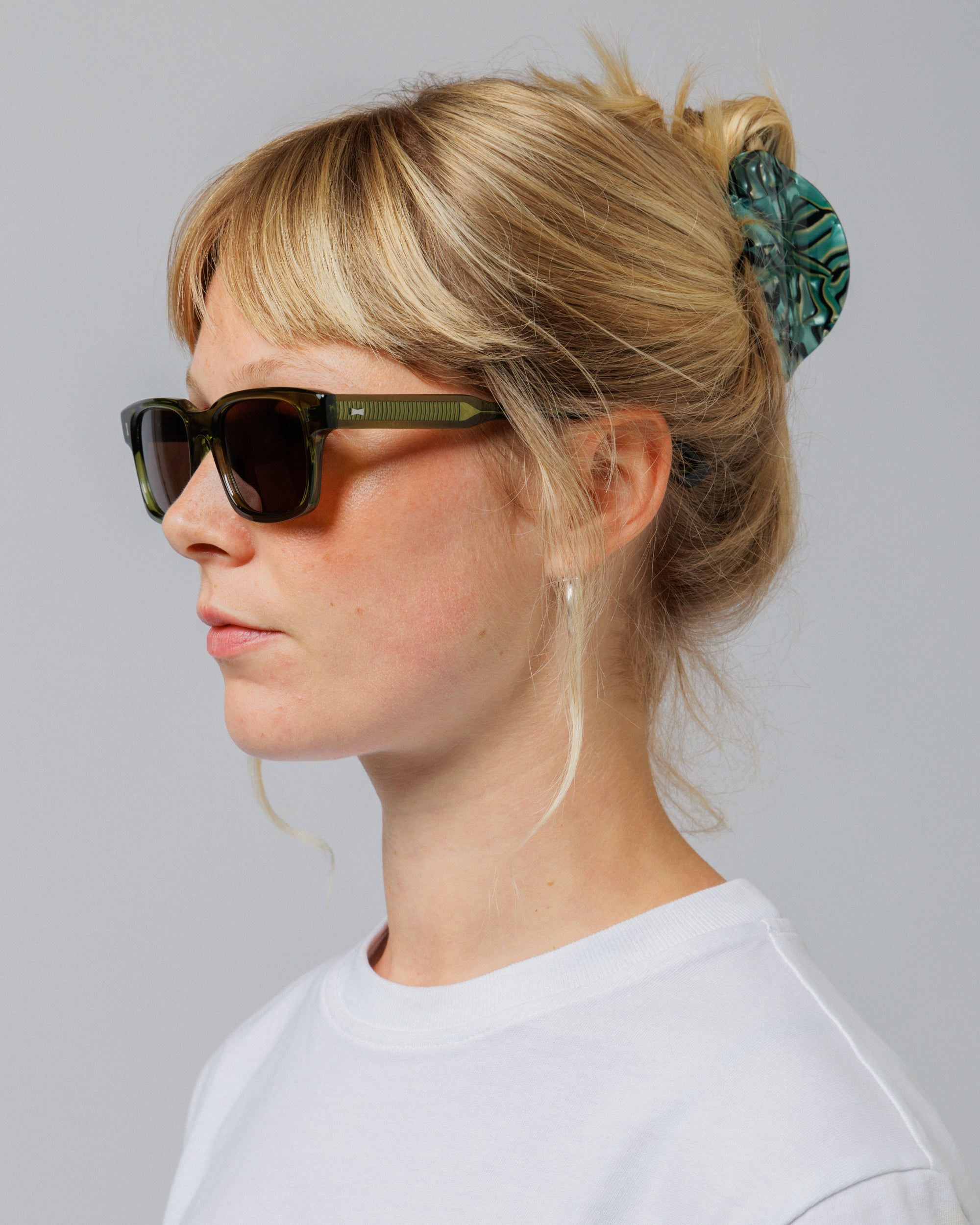 Female model wearing Solaris Sunglasses in khaki, three-quarter view
