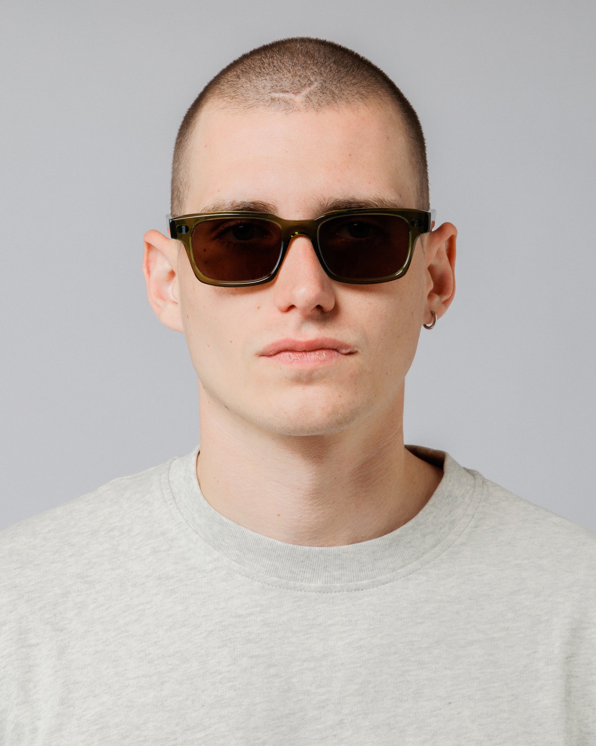 Male model wearing Solaris Sunglasses in khaki, front view