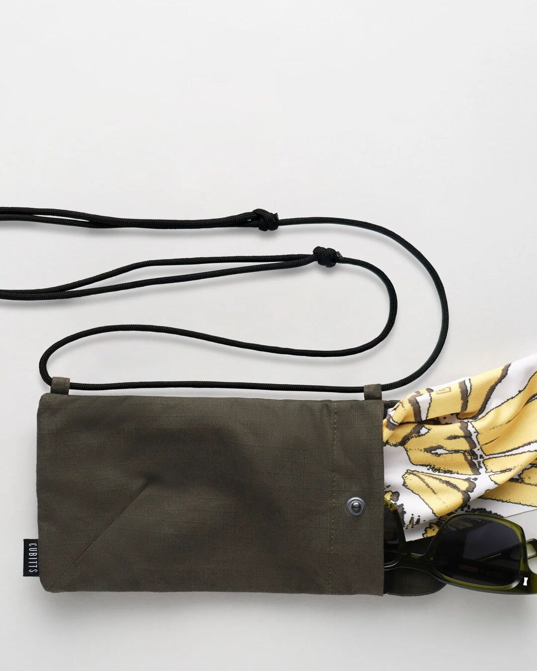 Cubitts x WAWWA Sunnies Sling in khaki with Solaris Sunglasses and printed cleaning cloth